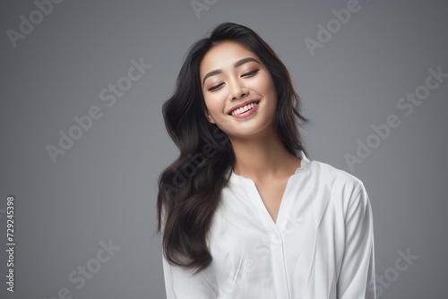 Serene young lady of Asian descent dons comfortable white loungewear, exuding a peaceful expression against a backdrop of pure white. Generative AI.