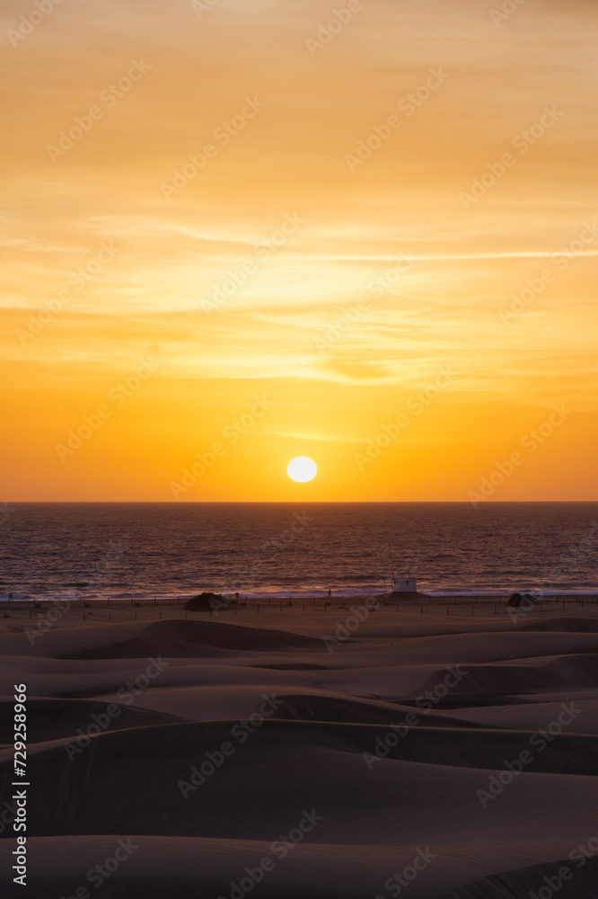 Fototapeta premium Asian Girl looking sunrise in Maspalomas. Spanish sunrise in Spain. Gran Canaria Sunrise and sunsets. 