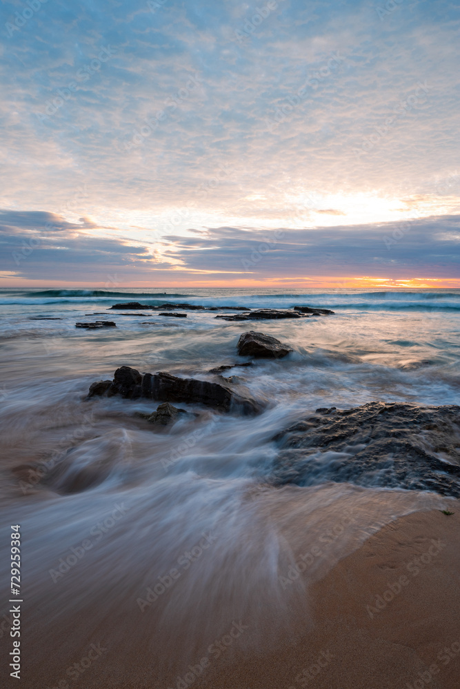 Flowing water over rocks on the beach shore. Flowing water over rocks on the beach shore.