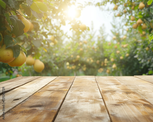 empty wooden table on a blurred background of a garden with yellow pears. display your product outdoors. mockup.
