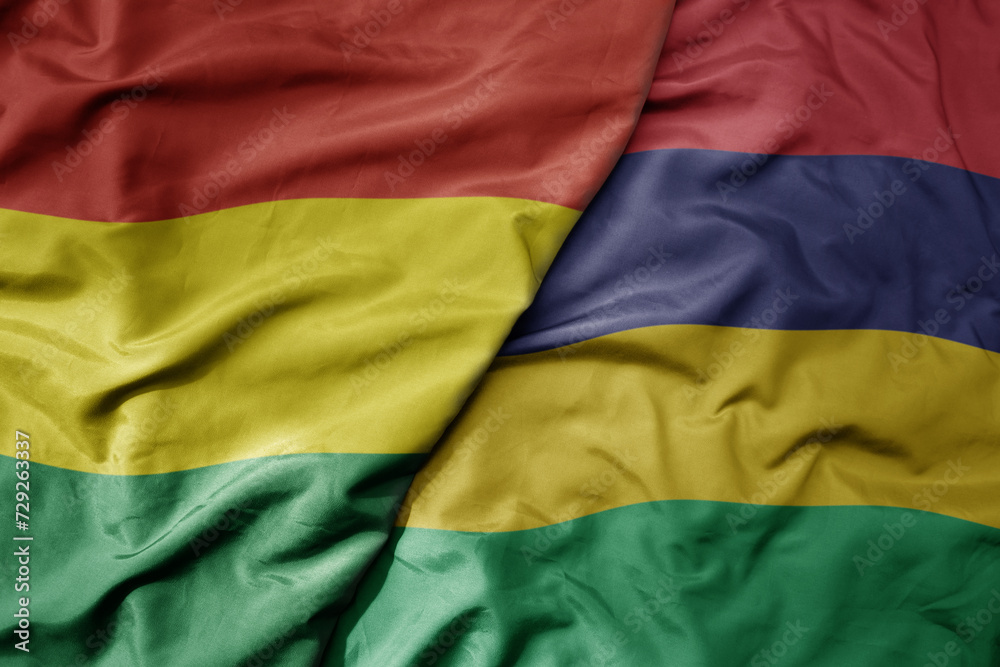 big waving national colorful flag of mauritius and national flag of bolivia . big waving national colorful flag of mauritius and national flag of bolivia .