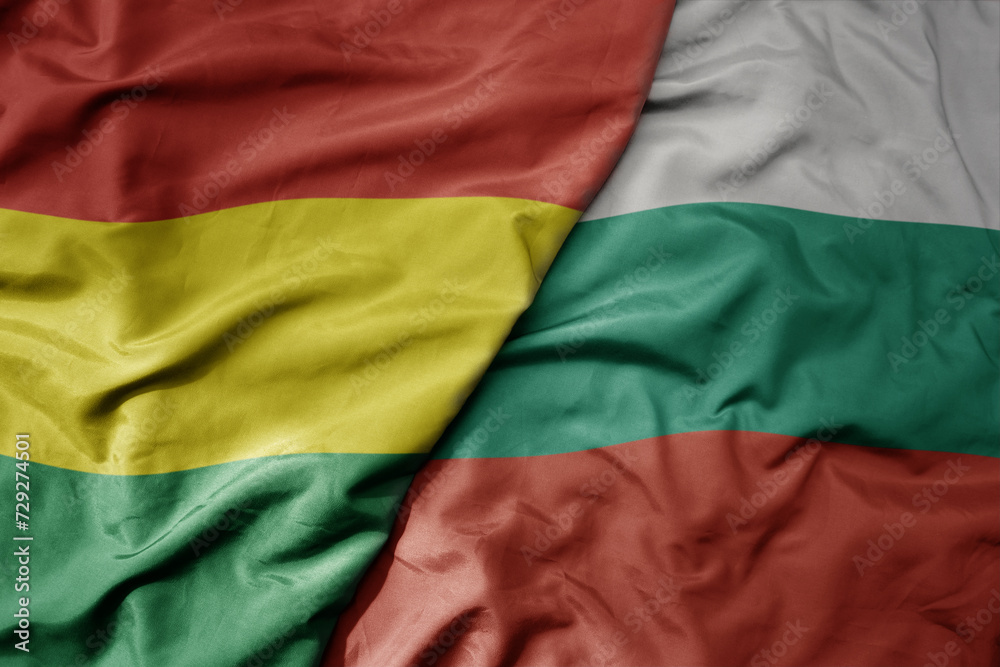 big waving national colorful flag of bulgaria and national flag of bolivia .