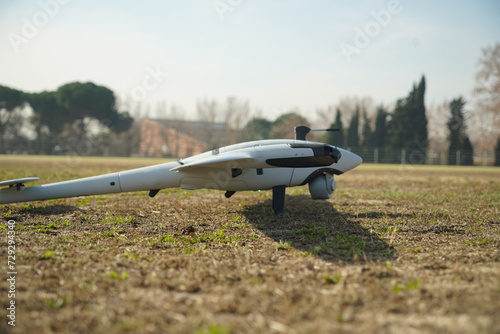 high tech uav plane about to perform its flight on a mission, on the ground with blurred background photo