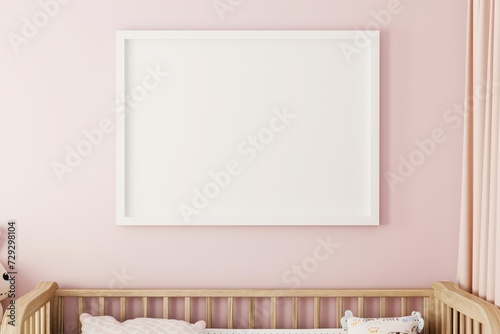white frame on a light pink wall in a nursery, crib underneath photo
