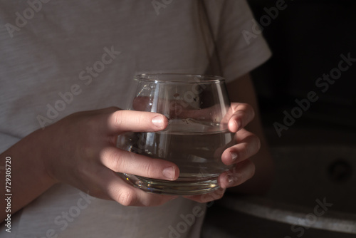 A glass of clean water in a child's hand