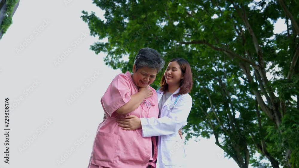 An old elderly Asian woman Do physical therapy and walking in the garden with her doctor. Concept of happy retirement With care from a caregiver and Savings and senior health insurance, health care An old elderly Asian woman Do physical therapy and walking in the garden with her doctor. Concept of happy retirement With care from a caregiver and Savings and senior health insurance, health care