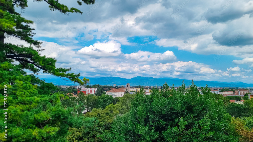Aerial panoramic view of historic city of Udine, Friuli Venezia Giulia, Italy, Europe. Viewing platform form castle of Udine. Cloudy overcast day. Distant view of mountains of Alps, border to Austria