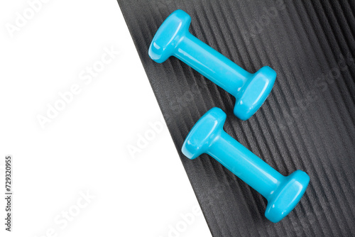 Yoga mat with a set of dumbbells isolated on a white background
