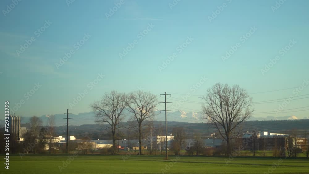 Stunning view on snow covered swiss alps from travelling train Stunning view on snow covered swiss alps from travelling train