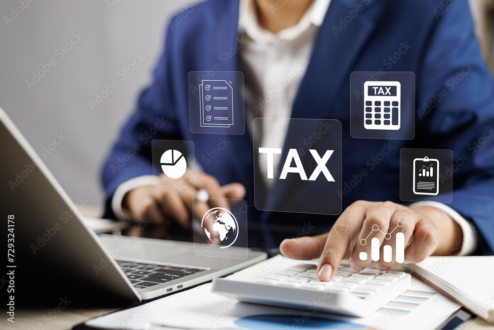 Tax and Vat concept. Government, state taxes concept. Businesman using tablet and laptop to complete Individual income tax return form online for tax payment. Data analysis, financial research. - obrazy, fototapety, plakaty 