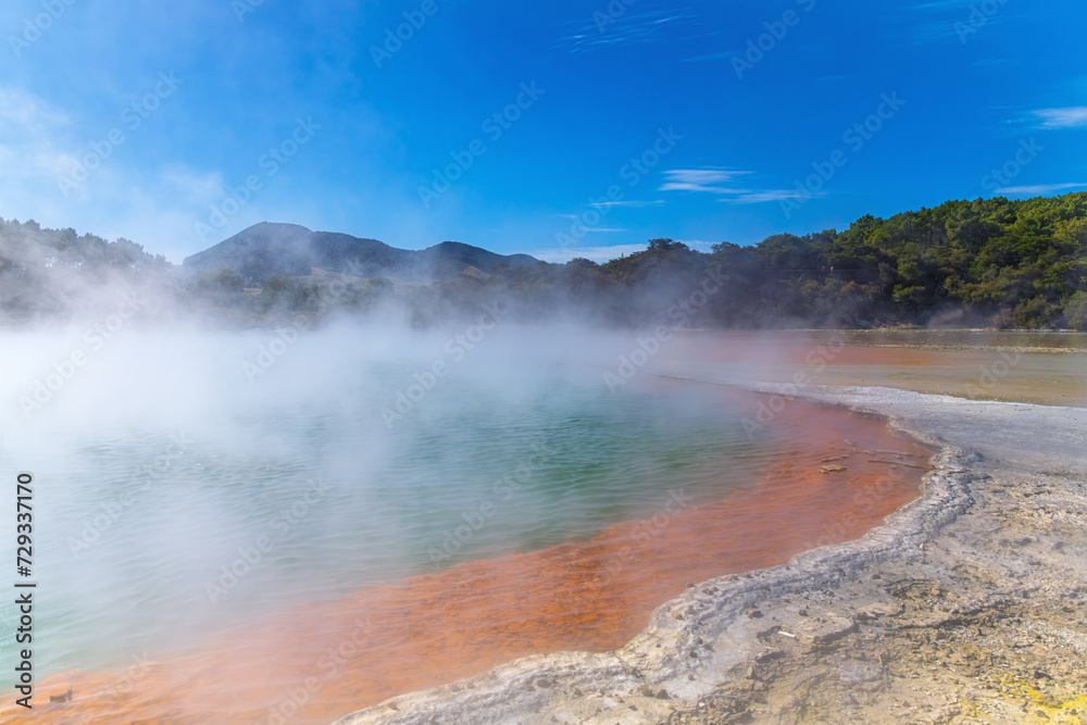View of the azure hot water pond in New Zealand. Capturing the natural beauty of geothermal wonders, ideal for travel brochures, wellness concepts, or any project highlighting unique landscapes.