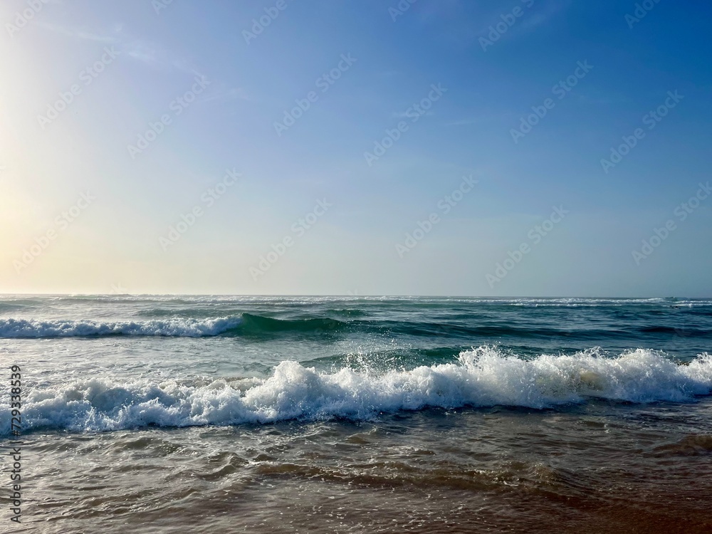 Seashore background, sea horizon, sea foam at the sandy coast