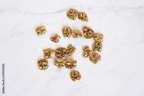 Walnuts are scattered on the marble table