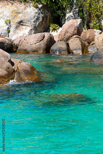 Abstract image of the contrast between the turquoise water and the rocks of Praia do Aventureiro, a tropical paradise in Ilha Grande, Angra dos Reis, Rio de Janeiro, Brazil.