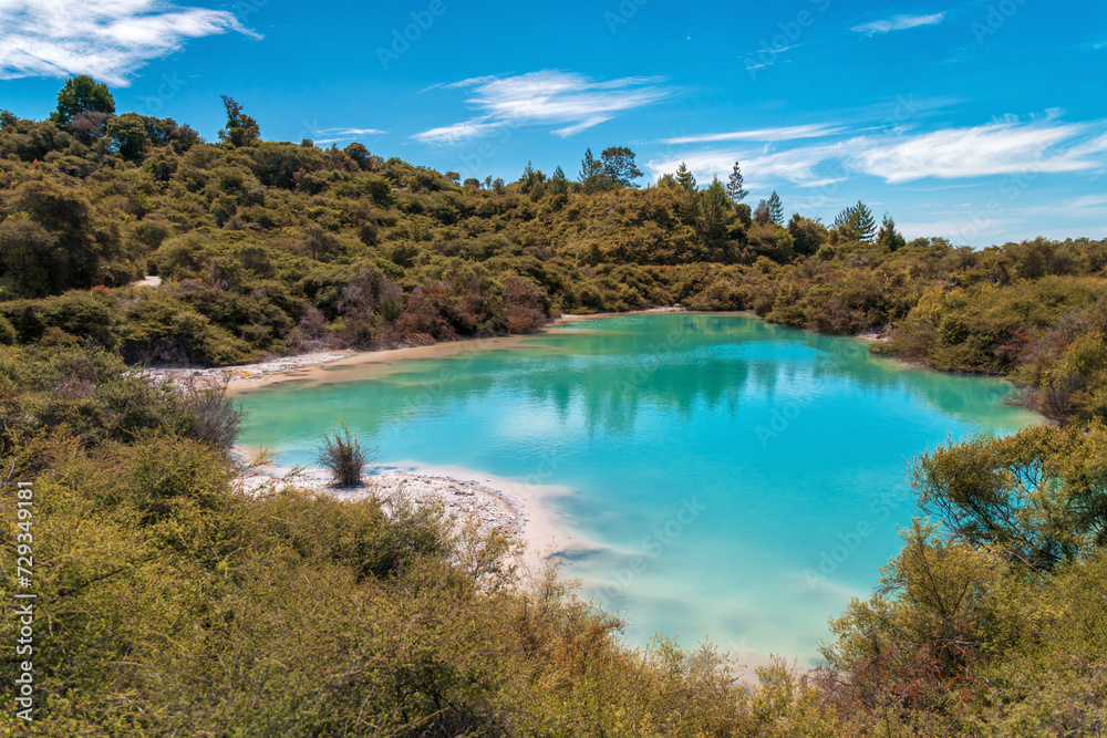 Breathtaking view of the azure hot water pond in Whakarewarewa Thermal Reserve, Rotorua, New Zealand. Capturing the natural beauty of geothermal wonders, ideal for travel brochures, wellness concepts.