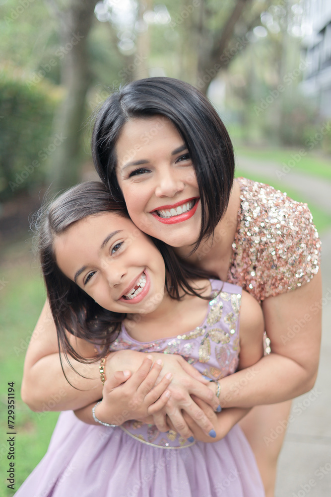 Mother and daughter mothers day photo in a park walking and playing hugging Mother and daughter mothers day photo in a park walking and playing hugging