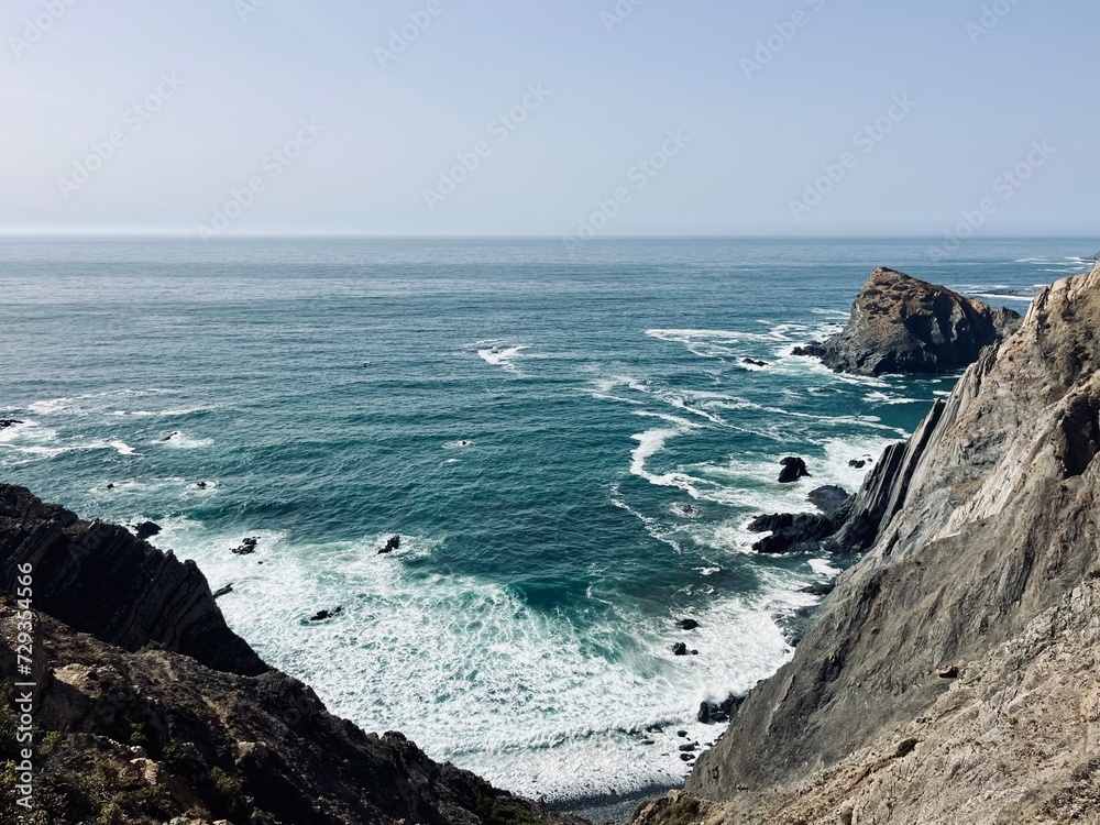 Rocky ocean coast, ocean bay, blue sky