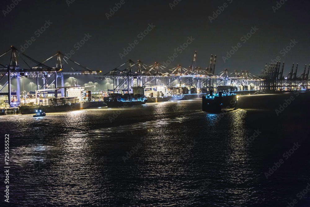Night shots of container ship in port being loaded with containers. Bremerhaven, Germany Night shots of container ship in port being loaded with containers. Bremerhaven, Germany