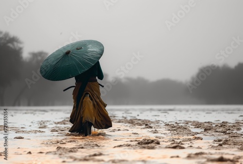 a woman in a green hat on an umbrella is riding a bike through the flooded area, in the style of dansaekhwa, karencore --ar 76:51 --v 6 Job ID: e2cc595a-1d02-49c0-acf4-616a1b5ac56e photo