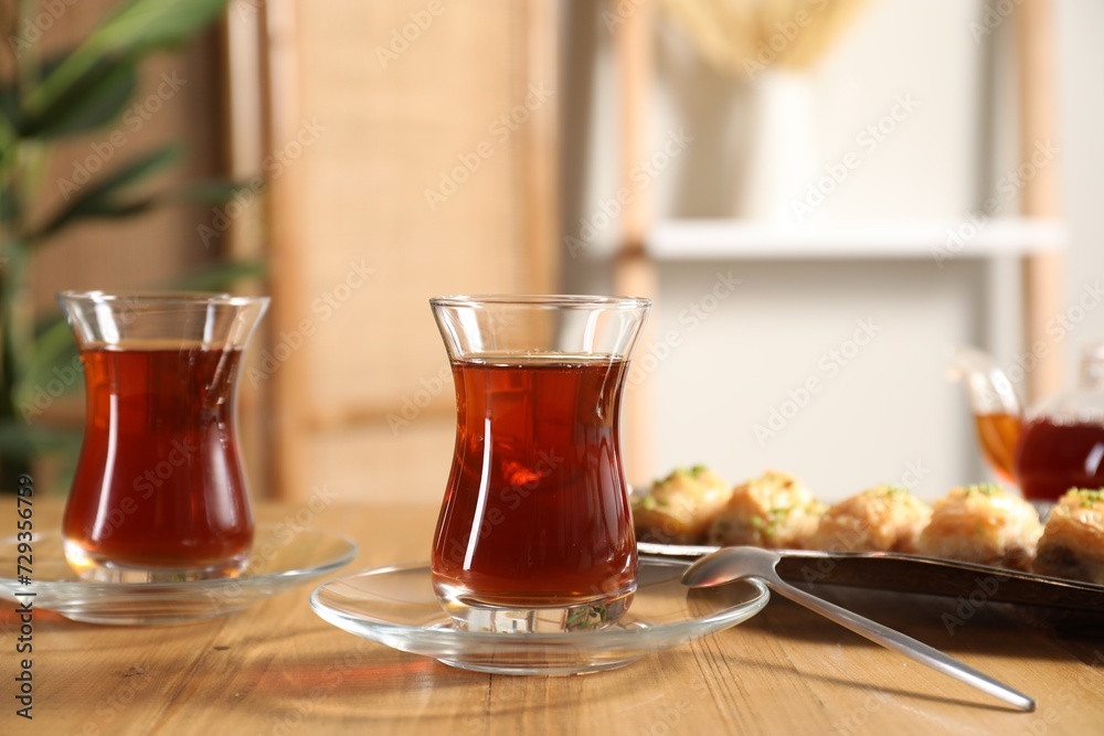 Traditional Turkish tea in glasses on wooden table Traditional Turkish tea in glasses on wooden table