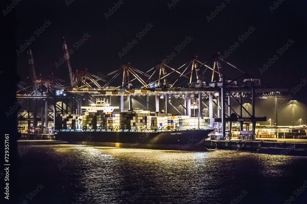 Night shots of container ship in port being loaded with containers. Bremerhaven, Germany Night shots of container ship in port being loaded with containers. Bremerhaven, Germany