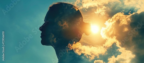 Woman's head reveals sun behind clouds. photo