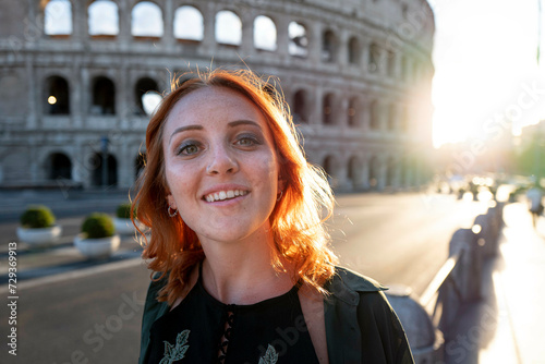 Young woman with red hair, near Colluseum, Rome, Italy photo