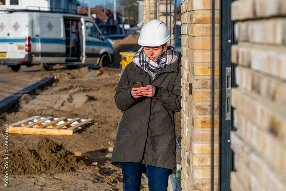 Female Construction manager walking around site on the phone