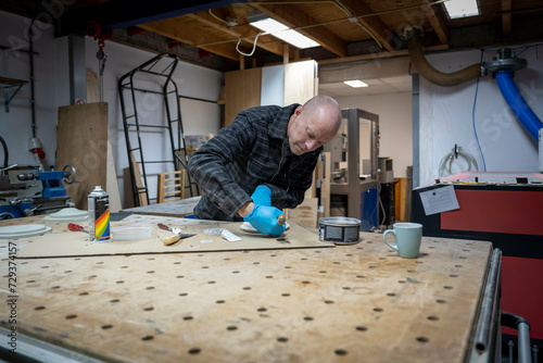 Carpenter working with resin epoxy photo