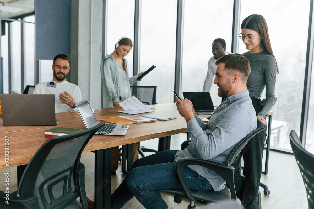 Positive attitude. Team of office workers are together indoors