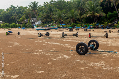 View of the beach used by local fishermen as a harborfor traditional fishing boats using car wheels on Sumenep beach, Madura island, Indonesia. photo