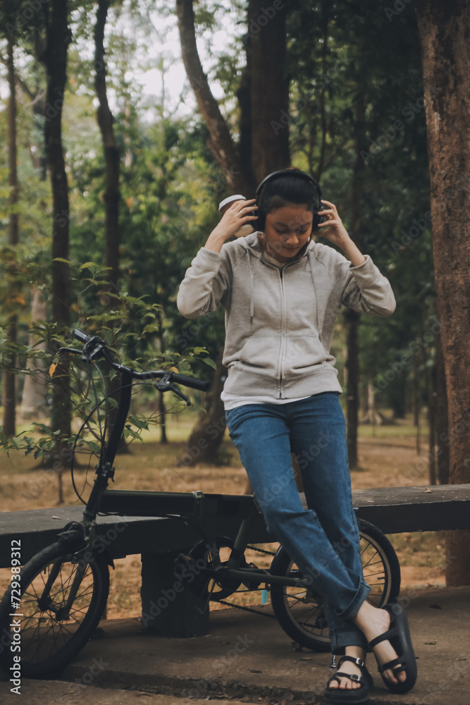Happy Asian young woman walk and ride bicycle in park, street city her smiling using bike of transportation, ECO friendly, People lifestyle concept.