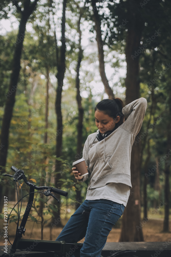 Happy Asian young woman walk and ride bicycle in park, street city her smiling using bike of transportation, ECO friendly, People lifestyle concept. Happy Asian young woman walk and ride bicycle in park, street city her smiling using bike of transportation, ECO friendly, People lifestyle concept.