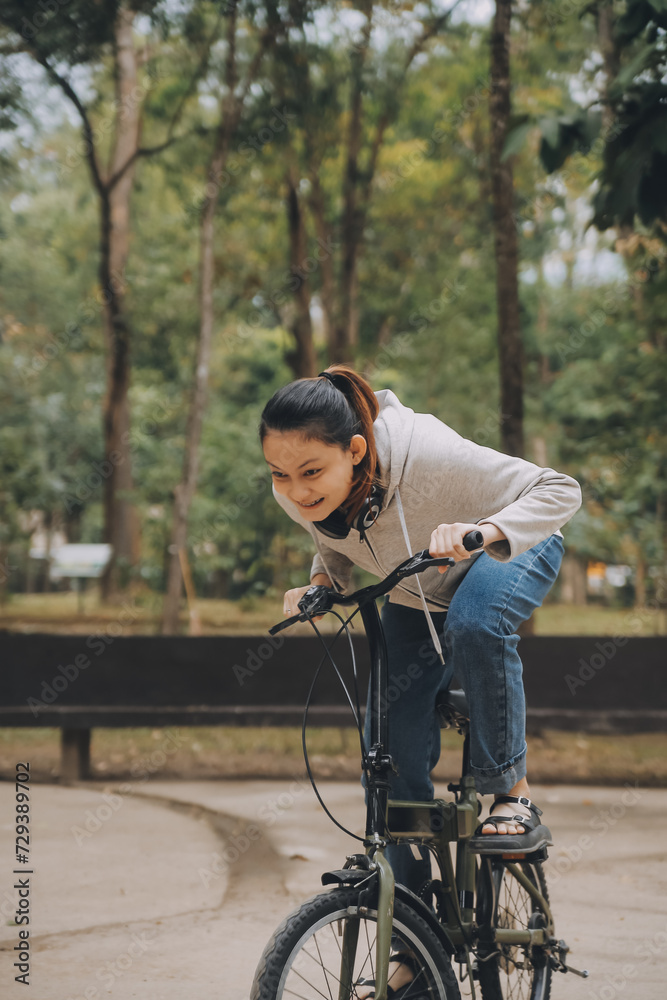Happy Asian young woman walk and ride bicycle in park, street city her smiling using bike of transportation, ECO friendly, People lifestyle concept. Happy Asian young woman walk and ride bicycle in park, street city her smiling using bike of transportation, ECO friendly, People lifestyle concept.
