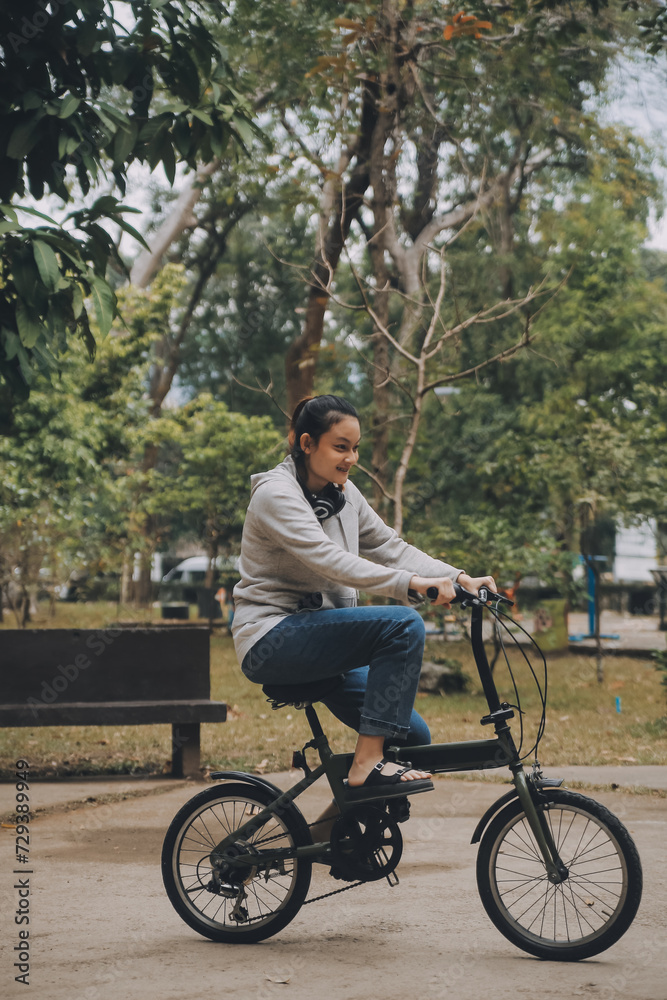 Happy Asian young woman walk and ride bicycle in park, street city her smiling using bike of transportation, ECO friendly, People lifestyle concept.