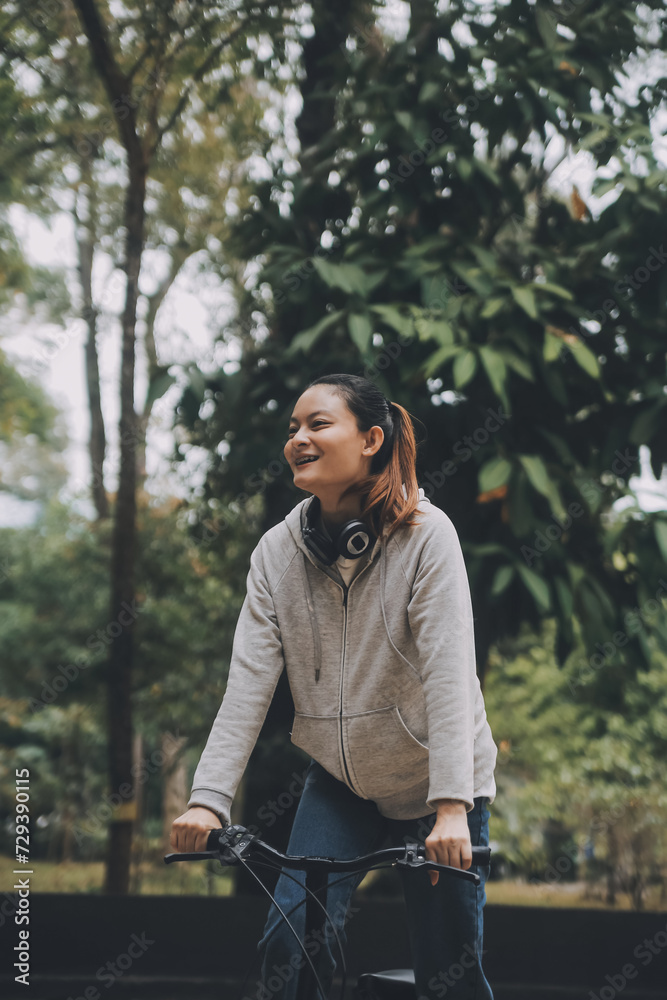 Happy Asian young woman walk and ride bicycle in park, street city her smiling using bike of transportation, ECO friendly, People lifestyle concept. Happy Asian young woman walk and ride bicycle in park, street city her smiling using bike of transportation, ECO friendly, People lifestyle concept.