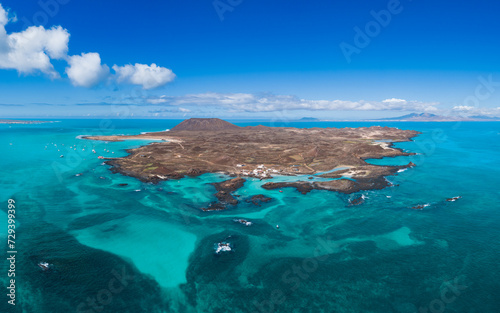Aerial panoramic landscape view of the beautiful secluded tropical looking natural bay and the island Isla de Lobos near Corralejo, Fuerteventura, Canary Islands, Spain