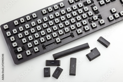 Disassembled Mechanical Keyboard with Removed Keycaps on a White Background