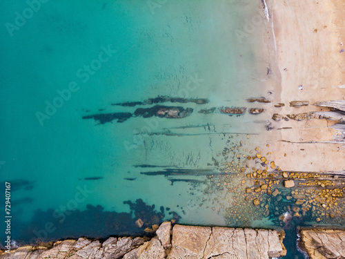 sea rocks beach turquoise water aerial topview
