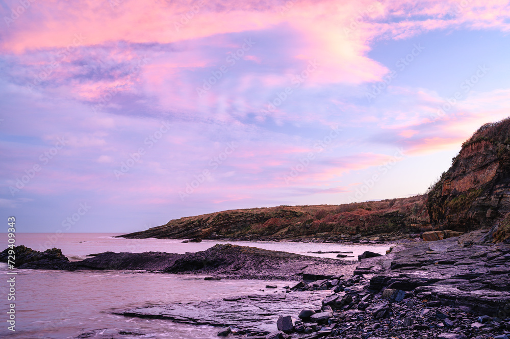 Pink Clouds over Howick Coastline, on the rocky shoreline  at Howick on the Northumberland coast, AONB which is now renamed as National Landscapes