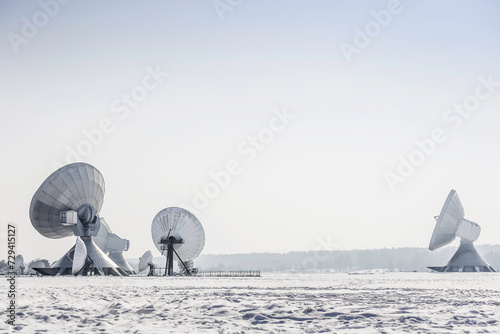 Uplink satellite station in winter landscape with snow and blue skies.  photo