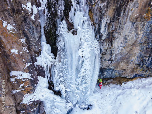 Frozen waterfall in the mountains near Almaty. Butakovsky waterfall in winter. Aerial photography of a waterfall in winter. photo