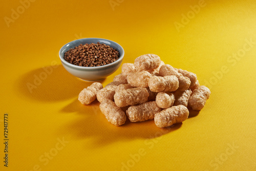 corn puffs with buckwheat on yellow background