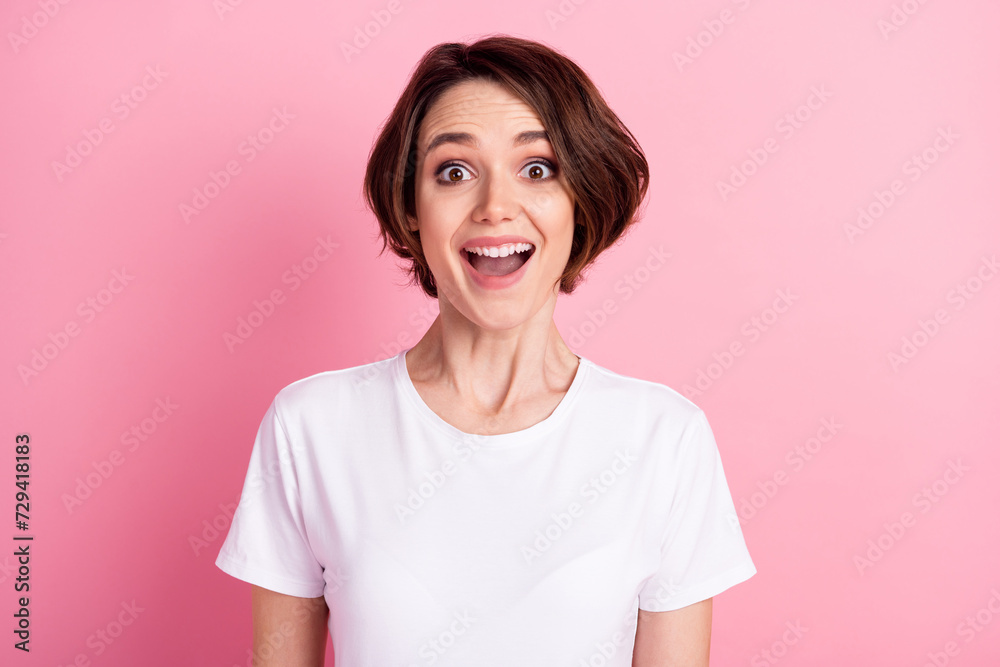 Photo portrait of amazed girl bob hairstyle smiling overjoyed isolated on pastel pink color background Photo portrait of amazed girl bob hairstyle smiling overjoyed isolated on pastel pink color background