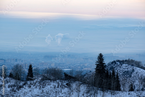 View of the city of Almaty in winter from the mountains. Almaty city before dawn.