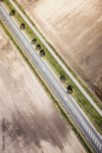 Aerial view of road through countryside with fields on both sides. photo