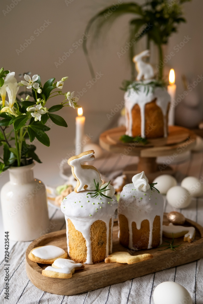 Traditional Easter bread kulich, rabbit cookies and eggs. Festive spring table