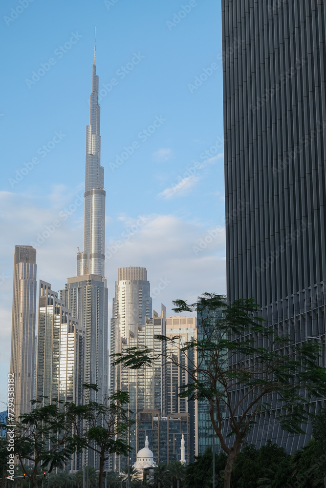 Fototapeta premium Futuristic and modern commercial and residential highrise tower skyscraper architecture with glass facades and clean lines in downtown Dubai, United Arab Emirates for millionaires and high society