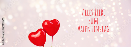 Happy Valentine's Day greeting card with German text - Alles liebe zum Valentinstag -Two red ballon hearts with bokeh lights - love background