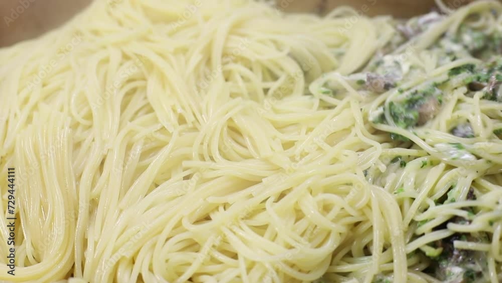 close-up stirring hot spaghetti with mushrooms and spinach. Italian close-up stirring hot spaghetti with mushrooms and spinach. Italian